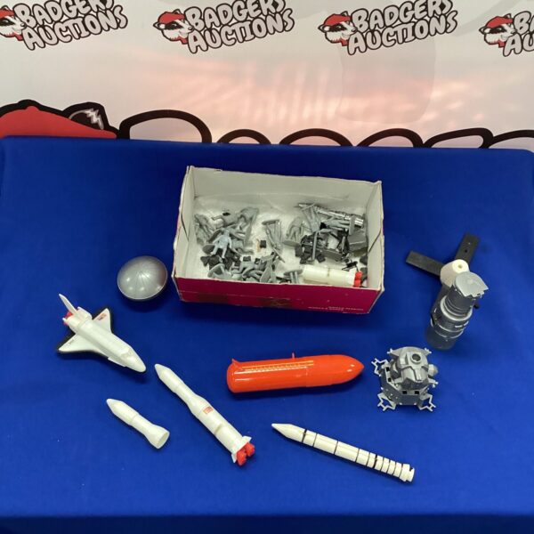 Vintage space toys lot featuring spacemen and rockets.