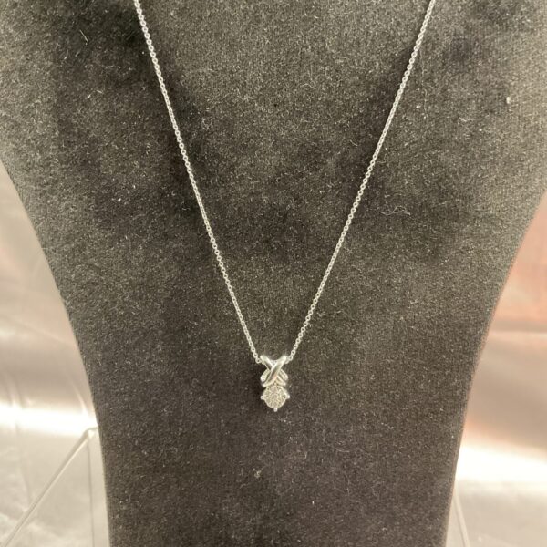 Delicate 925 silver diamond pendant necklace on a chain.