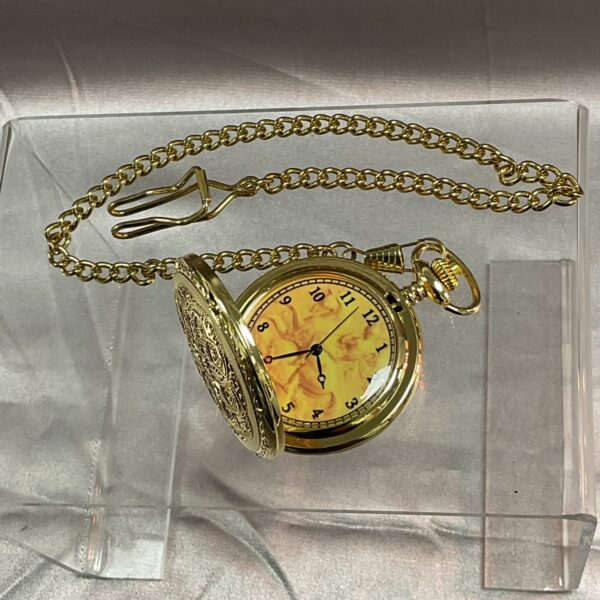 Gold quartz pocket watch with chain displayed on a dark background.