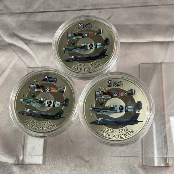 Three Royal Air Force £5 coins in protective capsules.