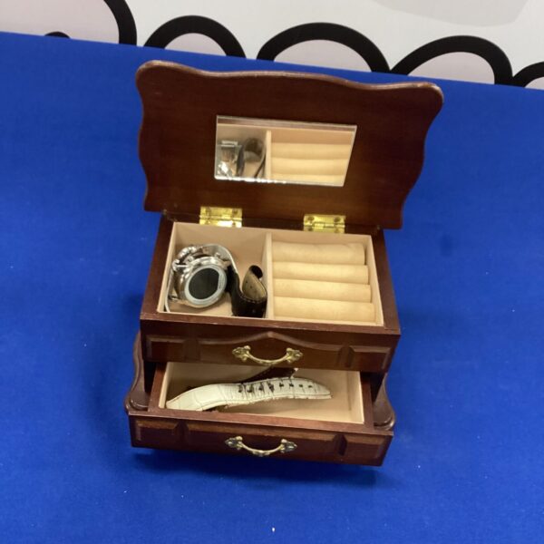 Small vintage wooden jewellery box with drawer open.
