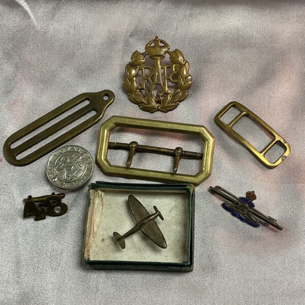 Vintage RAF military badges and brass tunic buckle collection.