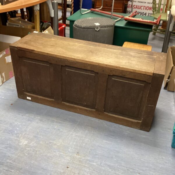 Front view of antique oak chest with panelling.