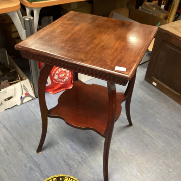 Ornate antique mahogany side table with curved legs.