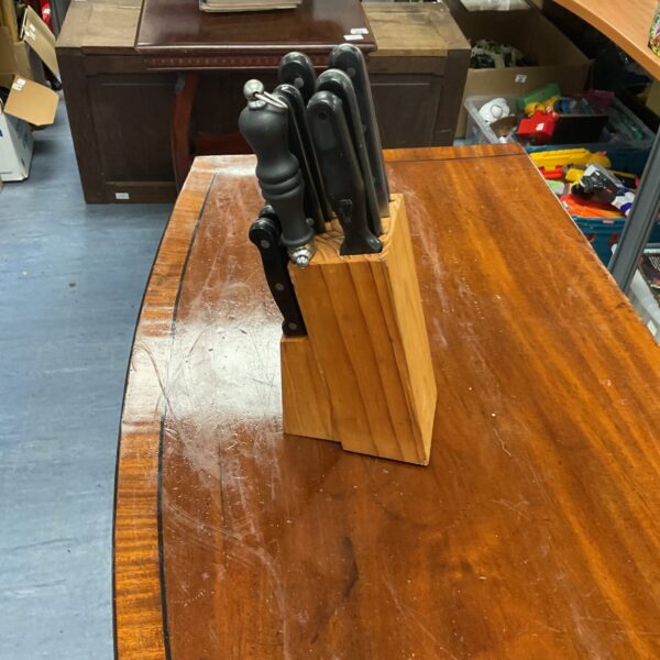 Full knife block set with stainless steel knives in wooden holder.