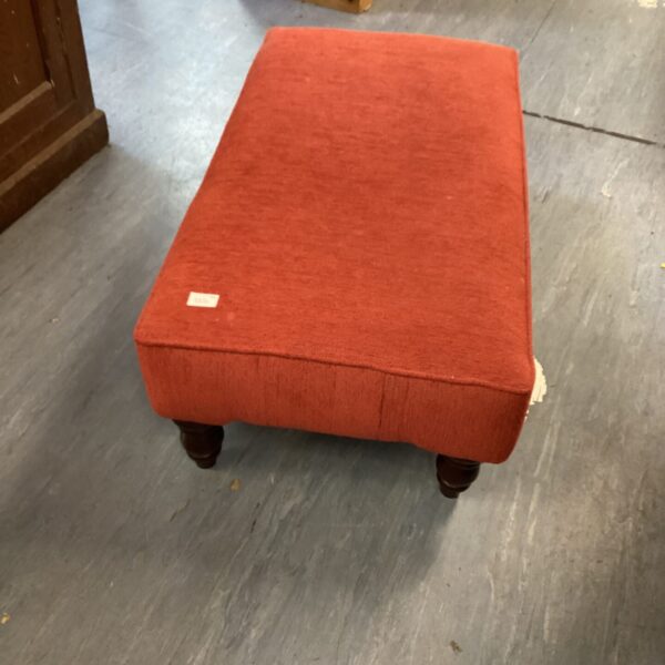 Vintage padded low bench with turned wooden legs.