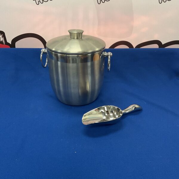 Polished stainless steel ice bucket with scoop for serving drinks.