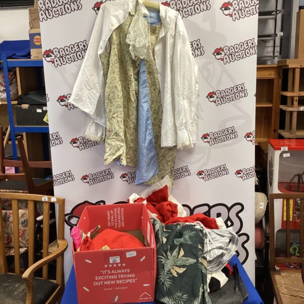 Box of colourful dress up clothes including Santa and pirate costumes.