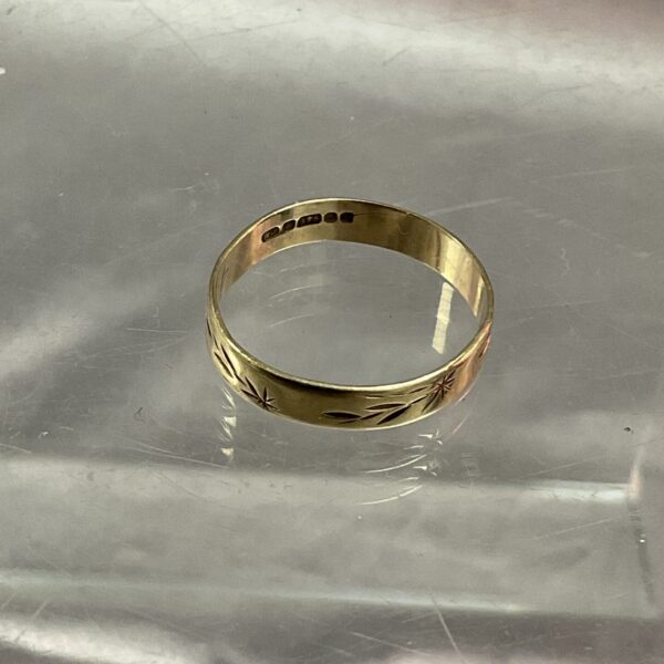 Close-up of a 9ct gold band ring, size R.