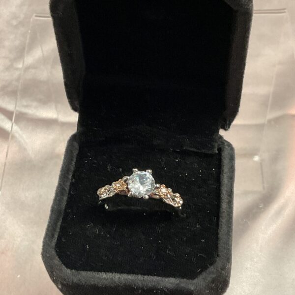 Vintage solitaire ring with a white stone in yellow and white gold.