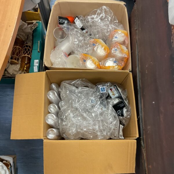 Assorted plastic cups and wine glasses in two boxes.