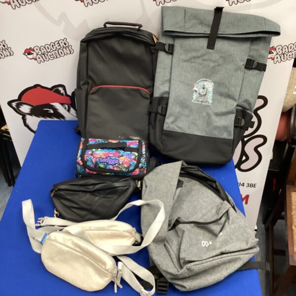 Lot of summit conference bags including Adobe and Meta branded backpacks.
