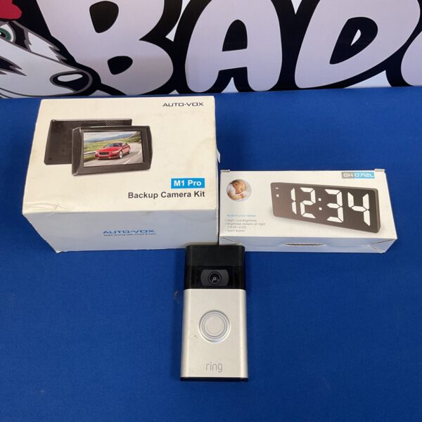 Auto-vox M1 Pro backup camera kit with digital alarm clock displayed.