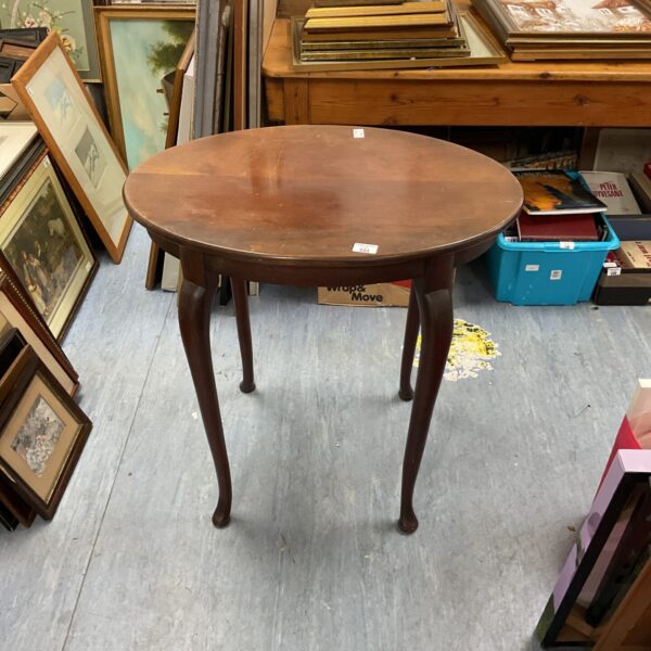 Elegant Edwardian mahogany table with oval top and slender legs.