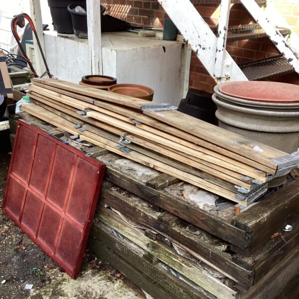 Quantity of weathered timber lengths for raised garden bed frames.