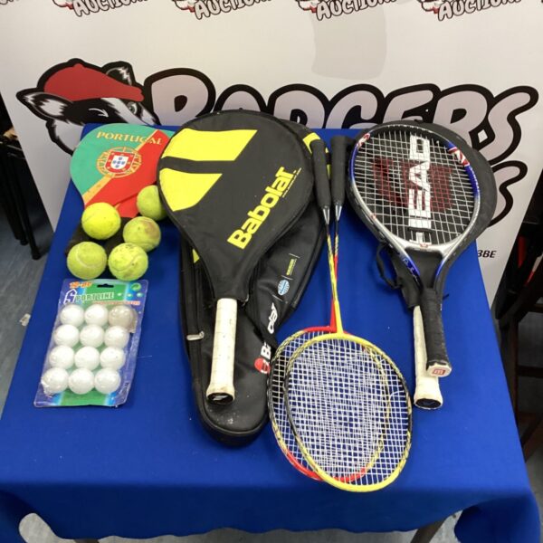 Mixed lot of tennis and table tennis rackets with balls.