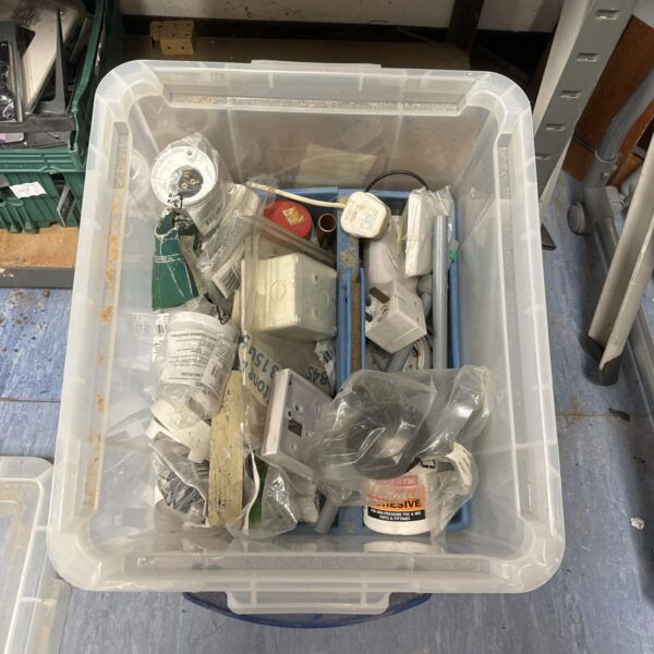 Assorted electrical components in a plastic storage box.