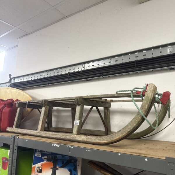 Vintage wooden sled with classic design for winter recreation.