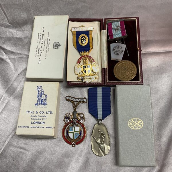 Lot of five vintage Masonic jewels with ribbon and enamel detailing.
