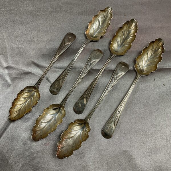 Group of six antique Georgian silver teaspoons with leaf pattern bowls.