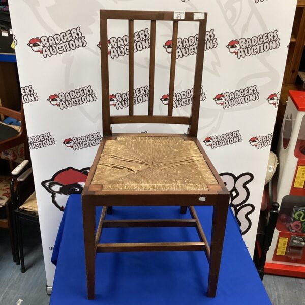 Antique rush seat chair with ladderback, front view.