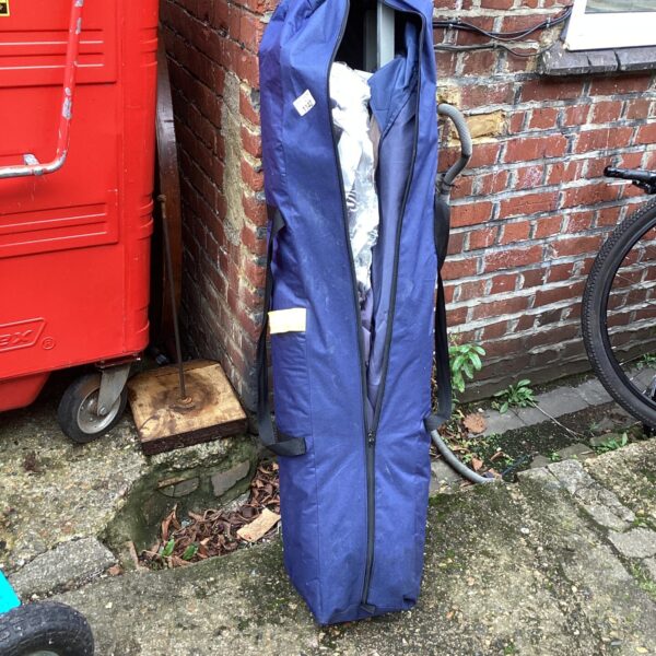 Navy blue telescopic gazebo folded for storage.