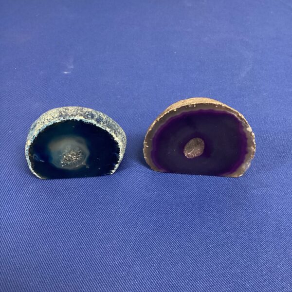 Polished geode pair with vibrant blue and purple agate crystals.
