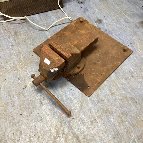 Heavy duty steel vice mounted on a steel plate for workshop use.