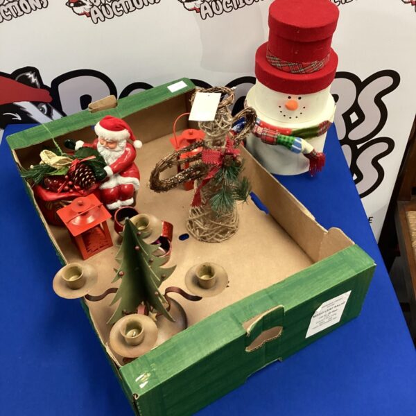 Box of Christmas decorations including snowman and Santa.
