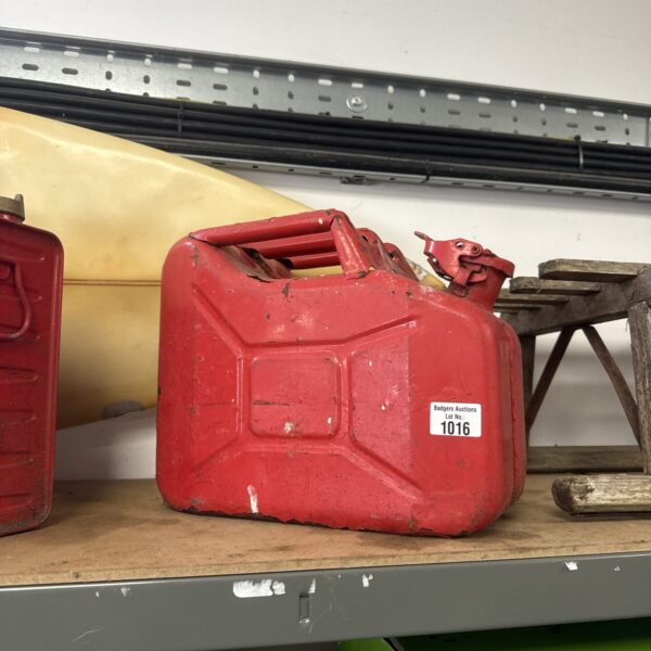 Vintage metal jerry can with handle and spout.