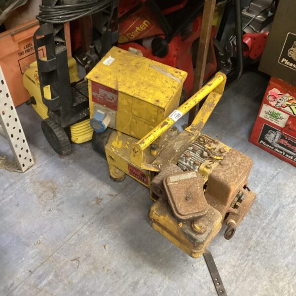 Vintage yellow petrol generator with 110v adapter for portable power.