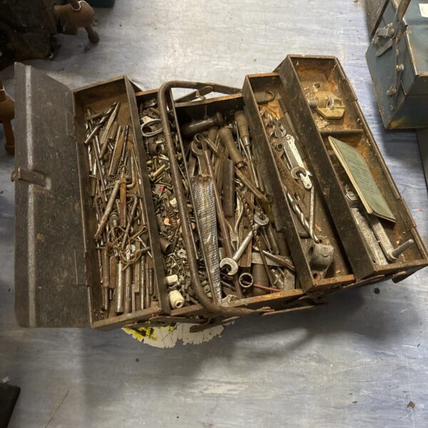 Vintage cantilever toolbox filled with antique tools for workshop storage.
