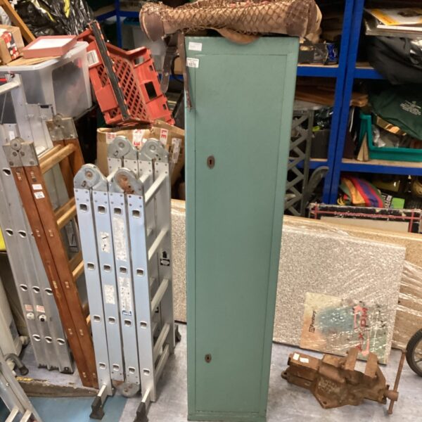 Vintage metal gun cabinet with keys and canvas cartridge bag.
