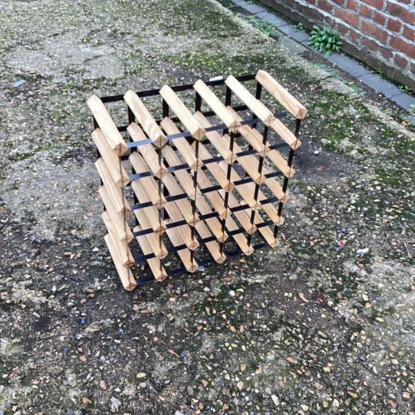 Rustic pine wine rack for storing wine bottles at home.