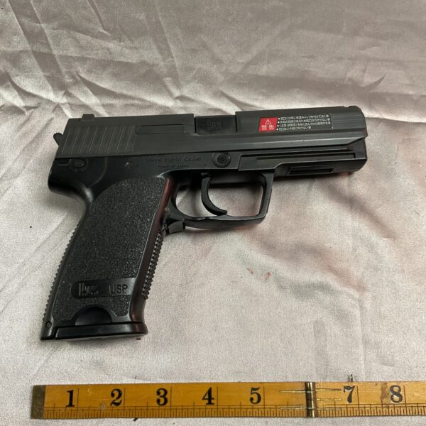 Black Tokyo Marui USP airsoft pistol, detailed replica.