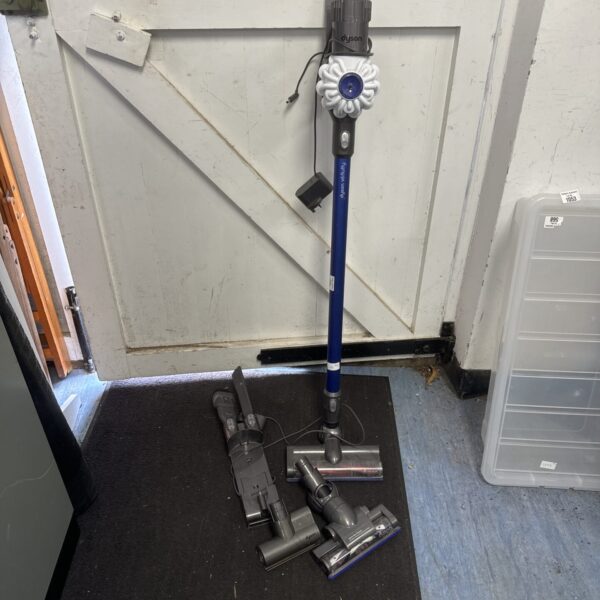 Dyson V6 Fluffy cordless vacuum cleaner with accessories.
