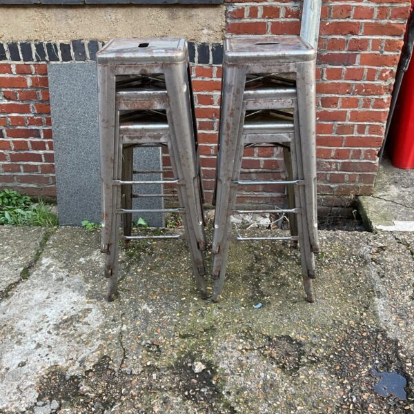 Six vintage metal bar stools with industrial style.