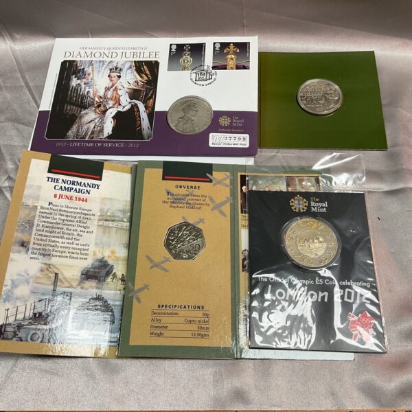 Four commemorative coins in original packing inc £5 coin and d day 50p