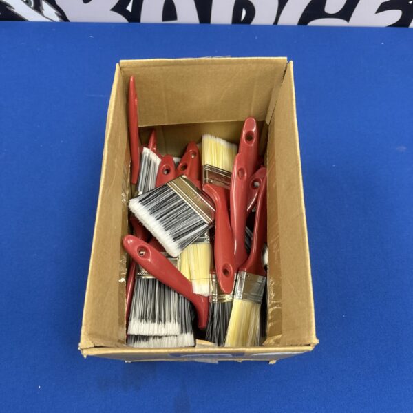 Assorted new paintbrushes in a cardboard box, ready for use.