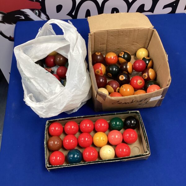 Collection of snooker and pool balls with chalks and marbles.