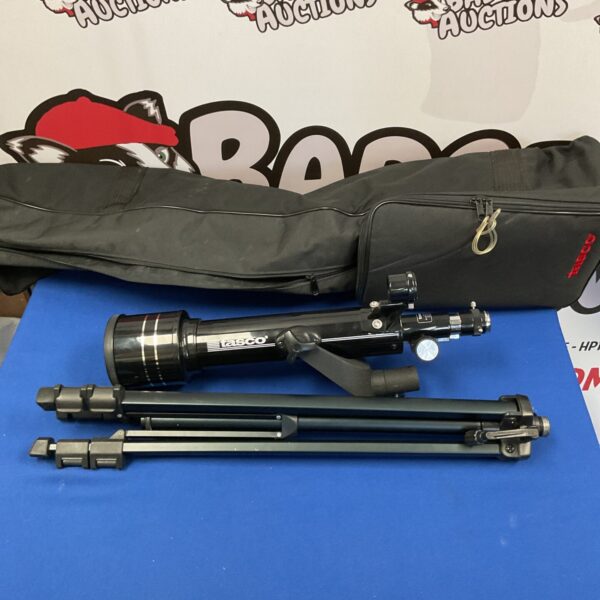 Vintage Tasco telescope with tripod for astronomy viewing.