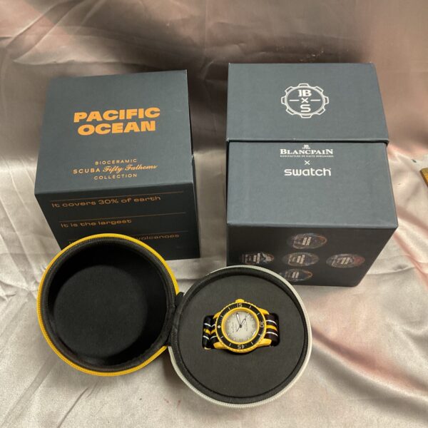 Blancpain Swatch Fifty Fathoms watch in box, front view.