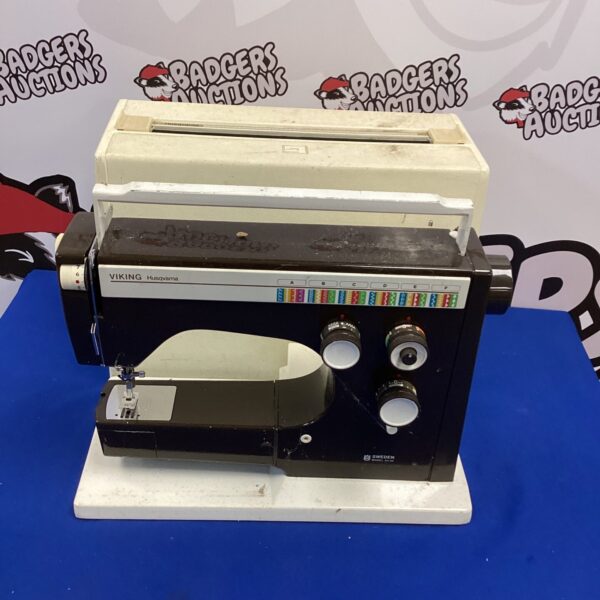 Vintage Husqvarna sewing machine with spare parts for collectors.