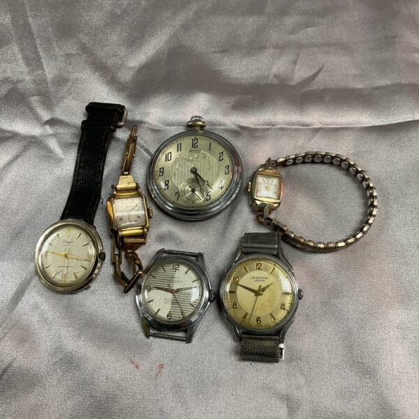 Group of six vintage watches, including a pocket watch.