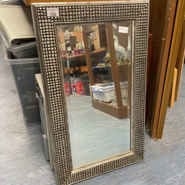 Ornate vintage wall mirror with gilded frame.