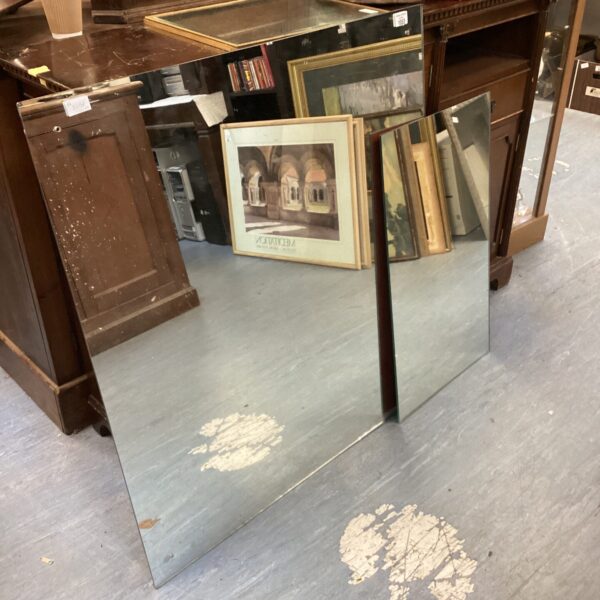 Pair of large unframed mirrors with vintage appeal.