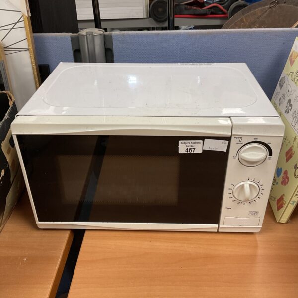 Front view of a white vintage microwave oven.