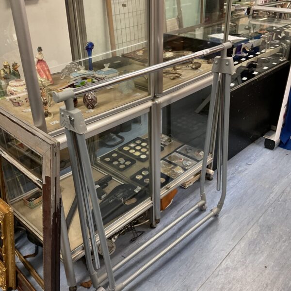 Metal folding clothes rail for portable garment display.