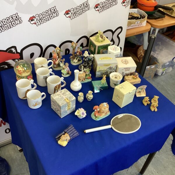 Collection of Wedgwood figurines and decorative trinkets on display.