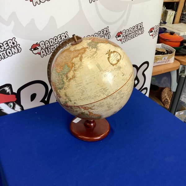 Antique globe on wooden base, vintage world map.